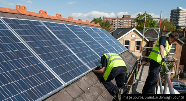 Image of solar panels being fitted to social housing roof